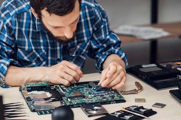 Technician repairing a laptop